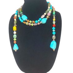 Embrace endless possibilities with the Joyous Journey necklace! This stunning piece features a vibrant cascade of genuine turquoise gemstones and colorful beads (60"). The innovative open-ended design allows you to wear it at numerous lengths. Long and elegant: Drape it for a touch of bohemian flair. Doubled for drama: Create a layered look for added impact. Shop Now and embark on your Joyous Journey! Adjustable Multicolor Lariat Long Necklace, Turquoise Lariat Beaded Necklace With Colorful Beads, Multicolor Beaded Lariat Necklace, Multicolor Gemstone Beaded Lariat Necklace, Bohemian Multicolor Turquoise Necklace With Faceted Beads, Turquoise Lariat Beaded Necklace With Natural Stones, Multicolor Lariat Beaded Necklaces With Natural Stones, Bohemian Turquoise Lariat Necklace With Natural Stones, Bohemian Multicolor Multi-strand Turquoise Necklace