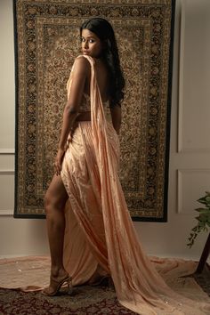 This baby peach pre-draped saree is a vision of elegance, crafted from Linen Satin fabric that glimmers with every movement. Paired with a Net blouse, the ensemble radiates sophistication and charm. The intricately hand-embroidered blouse adds a touch of glamour, making it perfect for a cocktail or reception, whether for the bride or her bridesmaids. With its timeless allure and delicate detailing, this saree is sure to captivate attention and leave a lasting impression on any special occasion.F Traditional Pre-draped Peach Saree, Fitted Peach Sharara With Sheer Dupatta, Peach Pre-draped Saree With Traditional Pallu, Peach Pre-draped Saree With Pallu, Peach Pre-draped Saree With Traditional Drape, Pink Formal Blouse With Traditional Drape, Elegant Peach Choli For Festive Season, Festive Peach Pre-draped Saree With Pallu, Elegant Festive Peach Choli