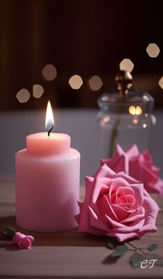 a pink rose sitting on top of a table next to a candle