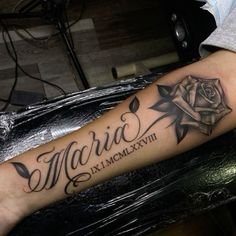 a man with a tattoo on his arm that says marra and is next to a rose