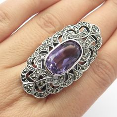 Great vintage condition.  925 Sterling Silver Vintage Amethyst & Marcasite Gem Statement Ring Size 7.25  Weight: 20.4g   WELCOME TO PAWN SHOP We are an actual pawn shop and have been in business for over 25 years. Since 1990, our establishment has been serving a variety of clients by providing them with short term cash solutions and options of liquidity regarding their treasured heirlooms. Acknowledging that today′s customers are very sophisticated and are looking for a variety of investments, o Vintage Sterling Silver Amethyst Ring With Stone Setting, Vintage Multi-stone Silver Gemstones, Vintage Silver Multi-stone Gemstones, Vintage Silver Amethyst Ring With Stone Setting, Vintage Stamped 925 Amethyst Ring, Vintage Oval Marcasite Jewelry, Vintage Amethyst Sterling Silver Ring, Antique Silver Amethyst Sterling Silver Ring, Vintage Silver Gemstones For Anniversary