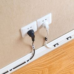 two plugs attached to the side of a wall with wires running through them,