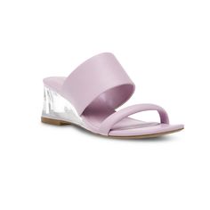 The Gaia Sandal is the perfect summer sandal that can be worn on any occasion. This stylish sandal is made with materials that provides extra comfort and flexibility while wearing. The clear wedge heel adds a modern look to the shoe. Description: - Closure Type: Slip-on- Heel Height: 2"- iFlex Technology- Faux Leather- Colors: Lilac and White Free Shipping Modern Wedge Sandals For Spring, Modern Clear Open Toe Sandals, Spring Clear High Heel Wedge Sandals, Spring High Heel Clear Wedge Sandals, Clear High Heel Wedge Sandals For Spring, Summer Jelly Sandals With Clear Strap, Modern High Heel Wedge Sandals For Spring, Modern Clear High Heel Sandals, Summer Party Leather Slides