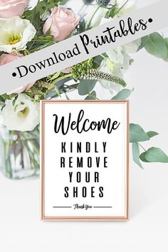 a vase filled with flowers next to a sign that reads, welcome kindly remove your shoes