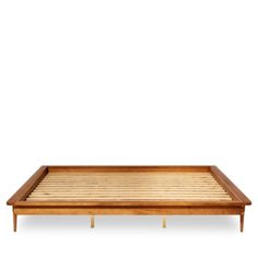 a wooden tray with two legs and a bamboo mat on the bottom, in front of a white background