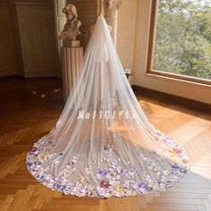 a wedding veil with flowers on the bottom