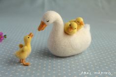 there is a small white duck with two chicks