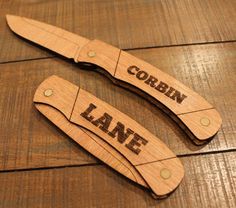 two personalized wooden knives with the names corbbin and lane engraved on them