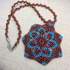 This beautiful Mandala necklace made in classic macrame technique in brown (Earth) and blue (Sky) colours.  This necklace will help you to  to find the unity with the nature  - Mother-Earth and Father-Sky. The necklace measures approx 16 inch / 41 cm.  Pendant (the Mandala) -3 x 3 inch / 7.5 x 7.5 cm   The necklace will come gift wrapped in nice organza gift pouch. This eye-catching necklace can be a perfect gift! Call again and thanks for looking! Sat Nam Artisan Brown Handwoven Necklace, Brown Macrame Necklaces For Festivals, Brown Macrame Necklace For Festival, Brown Handwoven Necklace For Gifts, Earthy Handmade Blue Necklace, Blue Macrame Necklace For Gift, Brown Macrame Nature-inspired Jewelry, Nature-inspired Brown Macrame Necklaces, Earthy Brown Macrame Jewelry