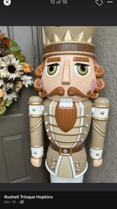 a wooden nutcracker with a crown on it's head is shown in front of a door