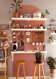 two wooden stools sitting in front of a pink wall with coffee signs on it