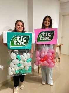 two girls are holding bags with balloons in them and one is holding a sign that says tic tac