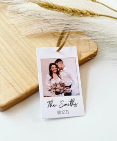 a couple holding each other in front of a wooden cutting board with wheat on it