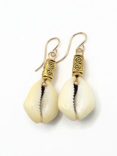 Handmade Natural Cowrie (Money Cowrie) Shell Earrings with Golden Pewter Beads, finished with Gold Filled Earring Hooks. Handmade Shell Jewelry In Natural Color, Handmade Natural Shell Jewelry, Natural Beaded Jewelry For Gifts, Traditional Nickel-free Earrings For Beach, Handmade White Beaded Brass Earrings, Artisan Gold Beach Jewelry, Artisan Gold Jewelry For Beach, Artisan Gold Jewelry For The Beach, White Bohemian Pierced Jewelry