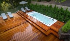 a hot tub sitting on top of a wooden deck