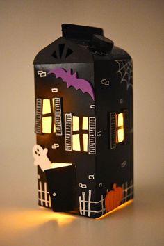 a paper house that is decorated with halloween decorations