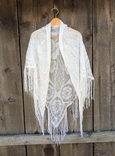 Lovely metallic silver lace piano shawl, 1980s vintage.  Perfect long drape & length, with luxurious fringe and woven Art Deco floral detailing.   An elegant accessory for a night out, or a Bohemian touch for your skinny jeans and cowboy boots. Very romantic, old-world, and timeless. Made in Japan 55% rayon, 30% nylon, 15% lurex roughly 73 inches at it's widest (not counting fringe) roughly 51 inches at it's longest (not counting fringe) fringe roughly 7 inches long Some general fabric wear, inc Spring Bohemian Shawl Scarf, Bohemian Fringe Shawl For Festivals, Bohemian Fringe Scarves One Size, Bohemian Scarves With Fringe, One Size, One Size Bohemian Scarves With Fringe, Bohemian Spring Shawl, Bohemian Fringe Shawl For Spring, Bohemian Spring Shawl With Tassels, White Bohemian Scarf For Fall