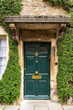 a green door with ivy growing over it