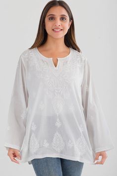 Our Saheli Embroidered Tunic is hand embroidered by women artisans in Uttar Pradesh, India. The embroidery motifs are first block-printed onto the garment and then the women do the embroidery in their homes, which allows them to do the work on their own schedule between other household work. Our soft embroidered cotton tunic tops feature fine embroidery on the front and back and are designed for a comfortable, elegant fit. Available in two sizes, S/M and L/XL. Traditional Long Sleeve Tops With Tonal Embroidery, Traditional Tops With Tonal Embroidery For Festive Occasions, White Folk Blouse With Resham Embroidery, Traditional White Top With Intricate Embroidery, Festive Traditional Tops With Tonal Embroidery, Multicolor Embroidered Folk Fabric, White Embroidered Cotton Tunic Top, White Cotton Embroidered Tunic Top, Traditional White Embroidered Top