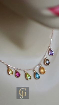 Celebrate your unique Zodiac sign or surprise a loved one with this stunning Multigemstone Rose Gold Teardrop Necklace. Featuring the vibrant colors of Citrine, Pink Sapphire, Peridot, Blue Topaz, Lemon Quartz, Smoky Quartz, and Amethyst, this beautiful birthstone necklace is the perfect accessory for any occasion. Find out more about the meaning behind each stone, and learn how you can personalize it to create a truly one-of-a-kind keepsake. Rose Gold Pear-shaped Gemstone Necklaces, Elegant Multi-stone Drop Necklaces, Rose Gold Pear-shaped Gemstone Necklace, Yellow Gold Teardrop Gemstones With Accents, Elegant Multicolor Teardrop Jewelry, Rose Gold Drop Gemstone Necklace, Rose Gold Drop Necklace With Gemstone, Elegant Multicolor Teardrop Gemstones, Multicolor Pear-shaped Gemstone Jewelry