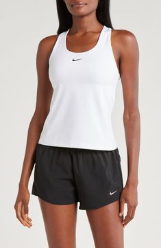 A built-in shelf-bra keeps you supported in this racerback tank top cut with signature Dri-FIT technology for cool, dry comfort as you work up a sweat. 20 1/2" length (size medium) Scoop neck Racerback Built-in shelf-bra Dri-FIT moisture-wicking technology 82% polyester, 18% spandex Machine wash, line dry Imported Nike Tops For Light Sports, White Go-dry Racerback Tank Top, White Racerback Tank Top For Sports, Nike Racerback Activewear For Light Sports, Nike Sporty Racerback Tops, White Racerback Top With Mesh Back, White Mesh Back Racerback Top, Nike Racerback Tops For Sports Events, White Racerback Functional Top