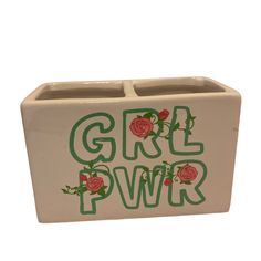 a ceramic box with the word girl power painted on it's side and roses