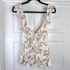 New With Tag Ivory, Floral Print Tank Top With Ruffle Shoulder Straps, V-Neck With Bow Size S Pit To Pit 15.5” Length 25” The Item Pictured Is The Exact One You’ll Receive. Open To Offers! Off White V-neck Top For Day Out, Off White V-neck Blouse For Day Out, White V-neck Top For Brunch, Cream V-neck Top For Beach, Cream V-neck Top For Daywear, Feminine Off-white V-neck Top, Feminine Off White V-neck Top, White V-neck Summer Blouse, Cream V-neck Blouse For Vacation