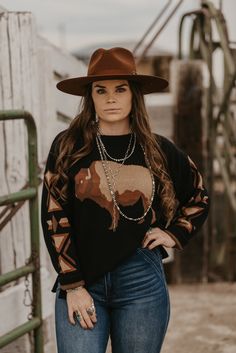 Out on the wide open plains! Long sleeve sweater with neutral tones and a roaming buffalo. Material: 100% Cotton Small (2/4) | Medium (6/8) | Large (10/12) | XL (14/16) | 2XL (18/20) Western Grunge Style, Womens Western Outfits, Cowboy Sweater, Gothic Western, Western Sweaters, Nfr Style, Cowgirl Style Outfits, Western Style Outfits, Western Outfits Women