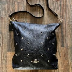 Coach Abby Duffle Black Crossbody Handbag; Black Pebbled Leather, Zipper Closure, Gold And Silver Accent Studs, Back Zipper Pocket, Interior Zipper Pocket, Detachable Adjustable Strap. Slight Wear On Ring Hardware (See Photo), No Scuff Or Rips O Leather Or Interior. Gently Used Handle Drop: 7.75” Strap Drop: 20.5” L: 9.75” H:12” W: 4” Coach Crossbody Hobo Bag With Zipper Closure, Chic Coach Shoulder Bag With Snap Closure, Coach Shoulder Bag With Snap Closure, Coach Black Shoulder Bag With Snap Closure, Black Coach Shoulder Bag With Snap Closure, Bags Coach, Black Pebbles, Handbag Black, Black Crossbody