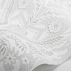 a white and grey wallpaper with an intricate design