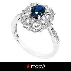 a blue and white ring with diamonds on it's shants, in the shape of a flower