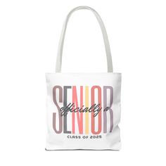 Senior 2025 Tote Bag, Class of 2025 Tote Bag, College Senior Tote, High School Senior Bag, 2025 Graduate Gift Bag, Officially a Senior Bag Available in 3 sizes to add both functionality and style, these custom-printed tote bags come with multiple handle colors to match your designs. Made with spun polyester, these bags feature double-stitched seams, cotton webbing straps, and nonwoven laminate lining for high-end durability. Your all-over print is created with dye sublimation for high-end visual 2025 Graduate, Bag College, Class Of 2025, College Senior, High School Senior, High School Seniors, Printed Tote Bags, Dye Sublimation, Custom Items