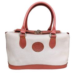 This vintage Coldwater Canyon handbag features a unique doctor bag shape with a sliding hook closure, offering a timeless and stylish look. Made from high-quality split leather in cream with brown accents, this bag is both durable and chic. While it shows minor wear around the edges and handles, it remains in beautiful condition. The bag is missing its original crossbody strap but has rings to easily attach a new one. The interior lining has been cleaned, with only a few pen marks inside, making it ready for use as your new go-to bag. Brand: Coldwater Canyon   Size: Medium   Measurements: Length: 11", Width: 7", Depth: 5.5", Handle Drop: 6"   Material and care: Split Leather, Clean interior lining   Condition: Good overall vintage condition, minor wear on edges and handles, missing crossbo Classic Leather Bag, Classic Purse, Vintage Leather Handbag, Unique Handbag, Everyday Handbag, Doctor Bag, Chic Leather, Top Handle Bags, Brown Leather Bag