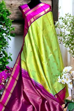 This exquisite korvai saree in lemon yellow shot with sea foam blue yielding to a beautiful pastel apple green is handwoven. The traditional rettai pettu borders in purple shot with magenta is adorned with peacocks in gold zari and and lattice twill pattern in silk threads. The pallu mirrors the borders with additional traditional motifs like paisleys and peacocks in gold zari! The blouse piece purple shot with magenta color. Approximate Length 6.5 mtrs (inclusive of blouse length)Height - 46 - 52" Approximate weight - 1.7 lbs Kindly Note : The colors you see on your device may vary due to the color reproduction, brightness and resolution of individual devices. If you'd like more clarity before your purchase, please contact our support team. Sea Foam Blue, Twill Pattern, Kanjivaram Silk Saree, Magenta Color, Traditional Motifs, Silk Cotton Sarees, Cotton Sarees, Apple Green, Peacocks