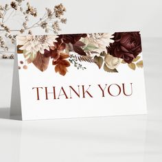 a thank you card with flowers on the front and bottom, in burgundy tones that say thank you