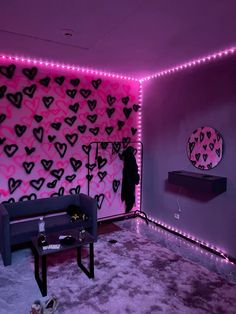 a living room with purple walls and hearts on the wall, pink lights in the corner