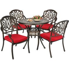 an outdoor table and chairs with red cushions