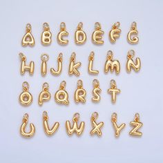 the letters and numbers are made out of gold colored metal, with small chains attached to them