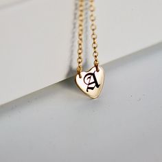 Old English Letter engraved heart necklace. Custom initial heart pendant. Perfect everyday necklace and great for layering with longer chains or a sweet gift for moms, sisters or friends. It's a great birthday gift. *** 14k gold filled heart charm*** Initials engrave by laser engraving by me.***Chain is 14" 16" or 18" available from drop down menu.*** Heart measurement : 10mm diameter. HOW TO ORDER !1) FROM FIRST DROP DOWN MENU !Choose your necklace length 14" 16" or 18" 2) IN THE PERSONALIZATIO Minimalist Personalized Heart Pendant Charm Necklaces, Minimalist Charm Necklace With Heart Charm For Personalized Gift, Minimalist Personalized Heart Pendant Charm Necklace, Dainty Heart Pendant Charm Necklace For Best Friend, Minimalist Heart Charm Necklace For Personalized Gift, Dainty Heart Charm Necklace For Best Friend Gift, Dainty Heart Charm Necklace For Best Friend, Dainty 14k Gold Filled Initial Necklace Gift, Dainty Engraved Heart Necklace For Everyday