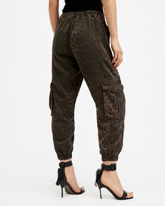 Cargo pants are so 90s, and we love it. Add a pair to your rotation - these are the Freda. Crafted from a lightweight fabric and shaped to a regular silhouette with a tapered, cuffed leg. Pocket detailing on the legs completes the laidback aesthetic.  These pants are designed to a regular fit High-rise Zip closure Two front pockets Two side pockets Elasticated cuffs Tapered slim leg Stretch Cargo Style Tapered Leg Bottoms, Stretch Tapered Leg Cargo Bottoms, Trendy Relaxed Fit Tapered Leg Cargo Pants, Trendy Tapered Leg Cargo Pants With Five Pockets, Urban Tapered Leg Cargo Pants For Spring, Spring Urban Tapered Leg Cargo Pants, Urban Style Tapered Leg Cargo Pants For Spring, Fall Cargo Style Bottoms With Cuffed Ankles, Fall Relaxed Fit Cargo Pants With Cuffed Ankles