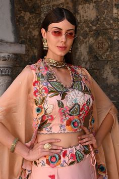 Peach attached cancan lehenga with 3D floral embroidery and pleat details. Paired with an embroidered padded blouse and cape with floral cutwork border. - Aza Fashions Sleeveless Lehenga With Floral Embroidery For Eid, Multicolor Floral Embroidery Blouse Piece For Reception, Multicolor Floral Embroidery Blouse For Reception, Party Wear Sets With Floral Embroidery For Reception, Floral Embroidered Party Wear Sets For Reception, Party Wear Unstitched Chanderi Blouse Sets, Unstitched Chanderi Blouse Sets For Party Wear, Diwali Georgette Choli With Floral Embroidery, Party Wear Set With Unstitched Chanderi Blouse