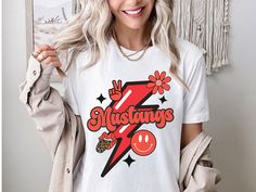 Mustang fans will love to support their team in this retro spirit shirt! We love the quality and softness of these Bella Canvas shirts with unisex sizing, and we think you'll love them too! Looking for more styles?  Check out our shop: https://josephineandjean.etsy.com Prefer Comfort Colors? We've got you covered! Check out our new shop: https://josephineandjeantoo.etsy.com The PRINT Our printer uses direct-to-garment printing to make our products. The design ink is sprayed on, then allowed to soak into the fibers of the garment resulting in fine quality prints and a smooth finish on the garment. SIZING AND COLORS * This unisex t-shirt feels like a well loved favorite.  * Women should buy their normal size or a smaller size for a more fitted look.   * See the pictures posted for this shirt Mustang Shirt, Mascot Shirt, Mustang T Shirts, Spirit Shirts, School Shirts, Favorite Shirts, New Shop, Comfort Colors, Fabric Care