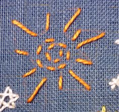 an image of carrots in the middle of a cross - stitch pattern on a piece of cloth