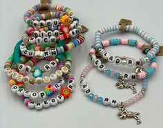 two bracelets with beads and charms on them, one has a cross in the middle