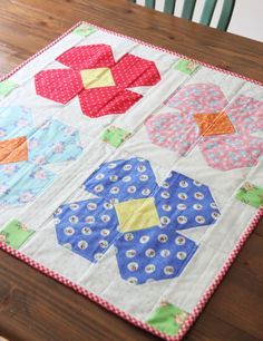 a quilted table runner on a wooden table