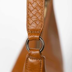 Make a bold statement with this handmade Saddle Shoulder bag in honey, crafted from the highest quality soft and supple genuine leather. Its classic hue adds a touch of elegance to any fall outfit, while the striking woven strap provides a modern edge. Handcrafted in Haiti, this limited production item is a testament to our commitment to sustainable fashion. Each piece is unique, showcasing exceptional craftsmanship and meticulous attention to detail. With ample room for your essentials, it effo Luxury Baguette Bag With Leather Handles For Everyday Use, Modern Leather Baguette Bag For On-the-go, Luxury Brown Baguette Bag With Leather Handles, Luxury Everyday Baguette Bag With Adjustable Strap, Modern Satchel Baguette Bag With Leather Handles, Modern Baguette Bag With Leather Handles For Everyday, Luxury Leather Baguette Bag With Leather Handles, Elegant Baguette Bag With Leather Handles For Everyday Use, Textured Leather Rectangular Baguette Bag For Travel