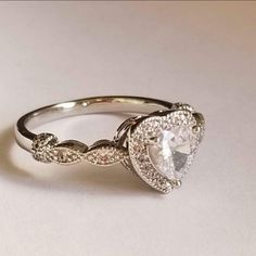 an engagement ring with a pear shaped diamond in the center