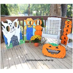 some pumpkins and jack - o'- lanterns are sitting on a porch deck