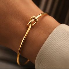 Adjustable Gold Knot Cuff Bracelet Is A Staple In Your Everyday Stack. Featuring A Sleek, Minimalist Design With A Distinctive Knot Centerpiece, This Bracelet Blends Timeless Elegance With Modern Simplicity. Made To Be Shaped To Your Wrist, And A Perfect Add To Your Stack. Key Features: - Material:Gold-Tone Alloy - Open Cuff Design For Easy Wear And Adjustable Fit - Daily Wear, From Casual To Formal - Adding A Refined Touch To Your Office Attire - Special Occasions Like Weddings Or Anniversaries Metal Bangle For Everyday Wear, Simple Adjustable Bangle Bracelet, Simple Adjustable Bracelet Bangle, Adjustable Simple Cuff Bracelet As Gift, Adjustable Bangle For Everyday, Simple Cuff Bangle Bracelet, Simple Adjustable Bangle Cuff Bracelet, Adjustable Simple Cuff Bangle Bracelet, Simple Adjustable Bangle As A Gift