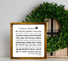 a wooden frame with a poem on it next to a box containing a green wreath